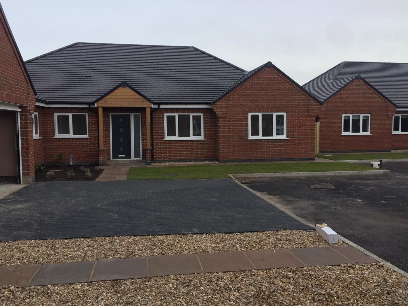 Finished red-brick bungalow with porch, block-paved drive and new lawn
